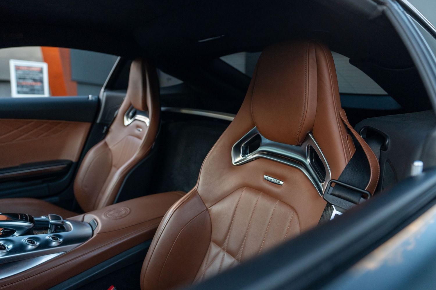 Sport seats with brown leather upholstery and metallic trim in luxury coupe.