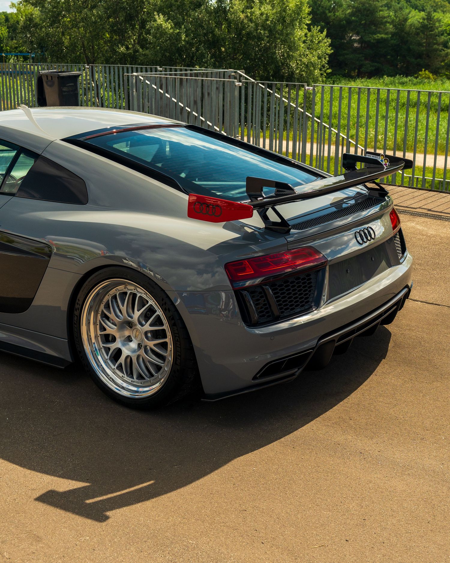 Grey Audi R8 with aftermarket wheels and lowered suspension shown from multiple rear angles.