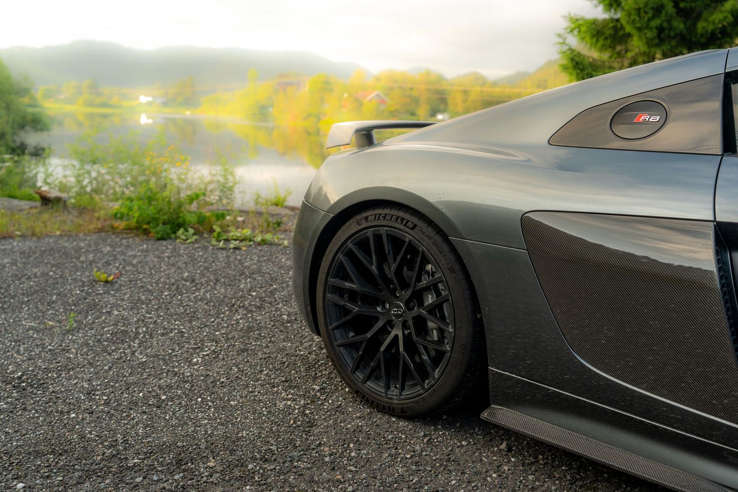 Close-up detail shots of BMW M4 performance parts including wheels and body panels.