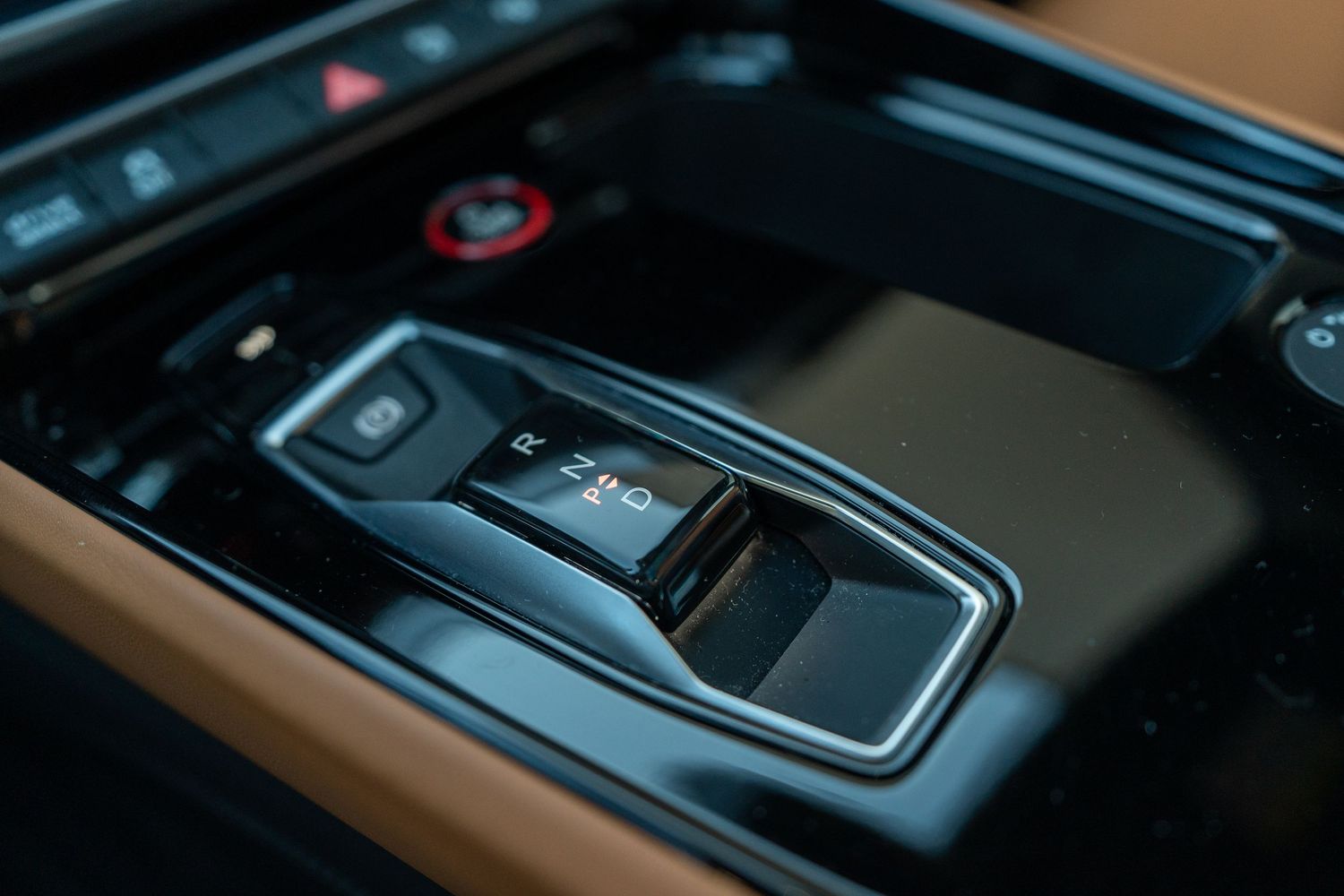 Close-up of Audi's electronic gear selector in black and chrome finish.