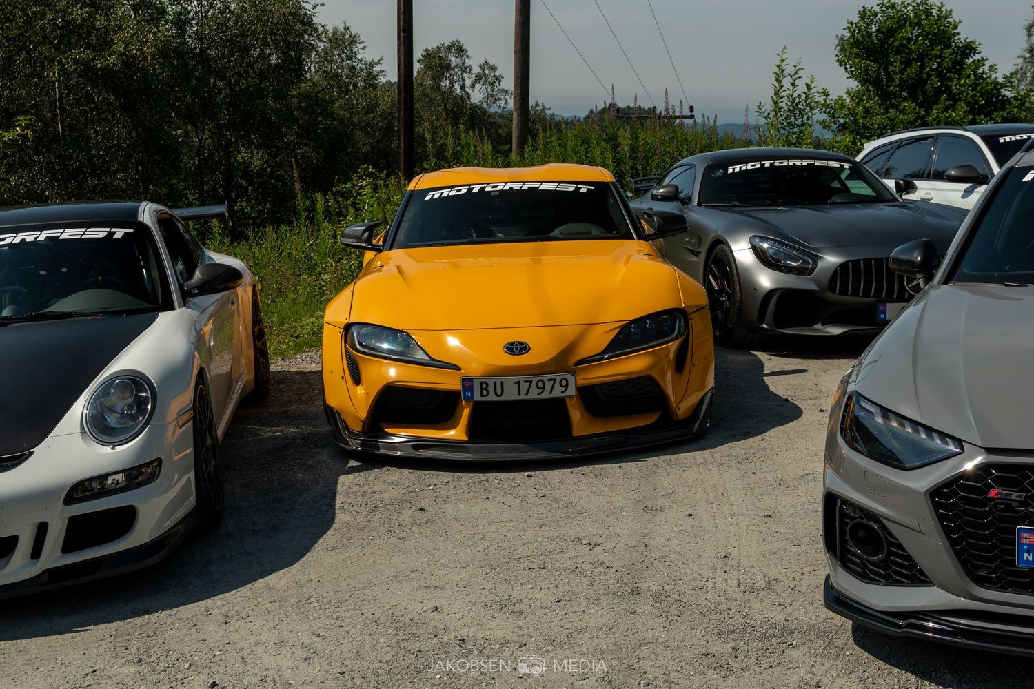 Collection of exotic supercars including Porsche, Lamborghini and Ferrari models parked together.