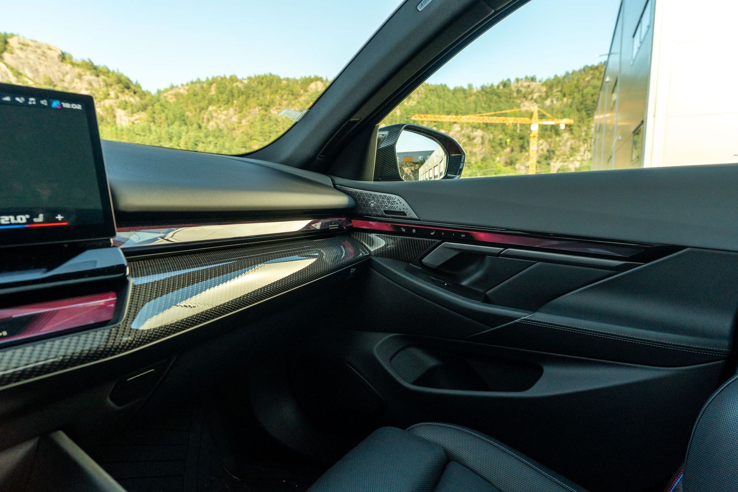 Luxurious BMW dashboard interior with ambient lighting and digital displays.