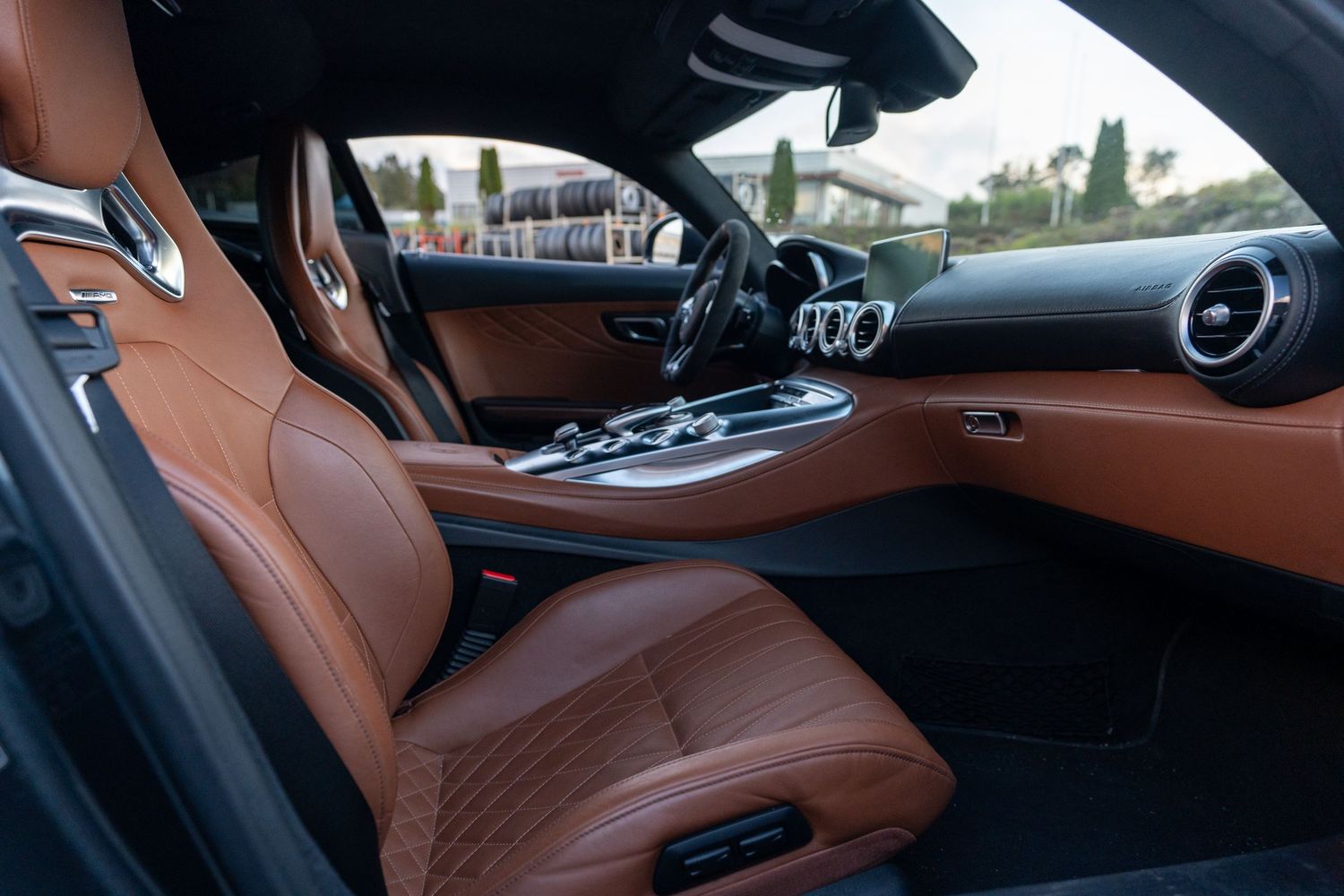 Wide-angle view of premium brown leather interior with sport seats and modern dashboard.