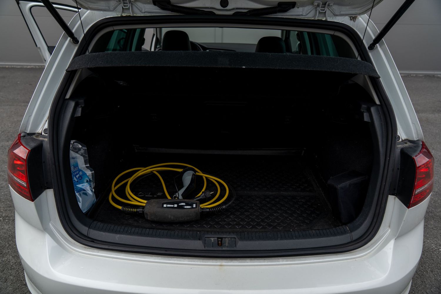 Multiple views of a vehicle's open cargo area showing empty trunk space from different angles.