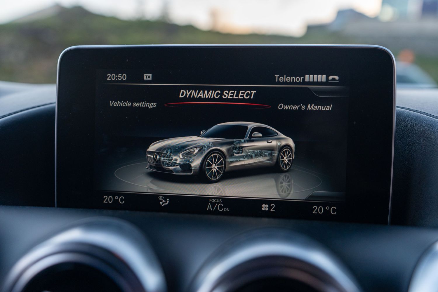 Mercedes vehicle infotainment display showing dynamic select menu with car silhouette graphic.