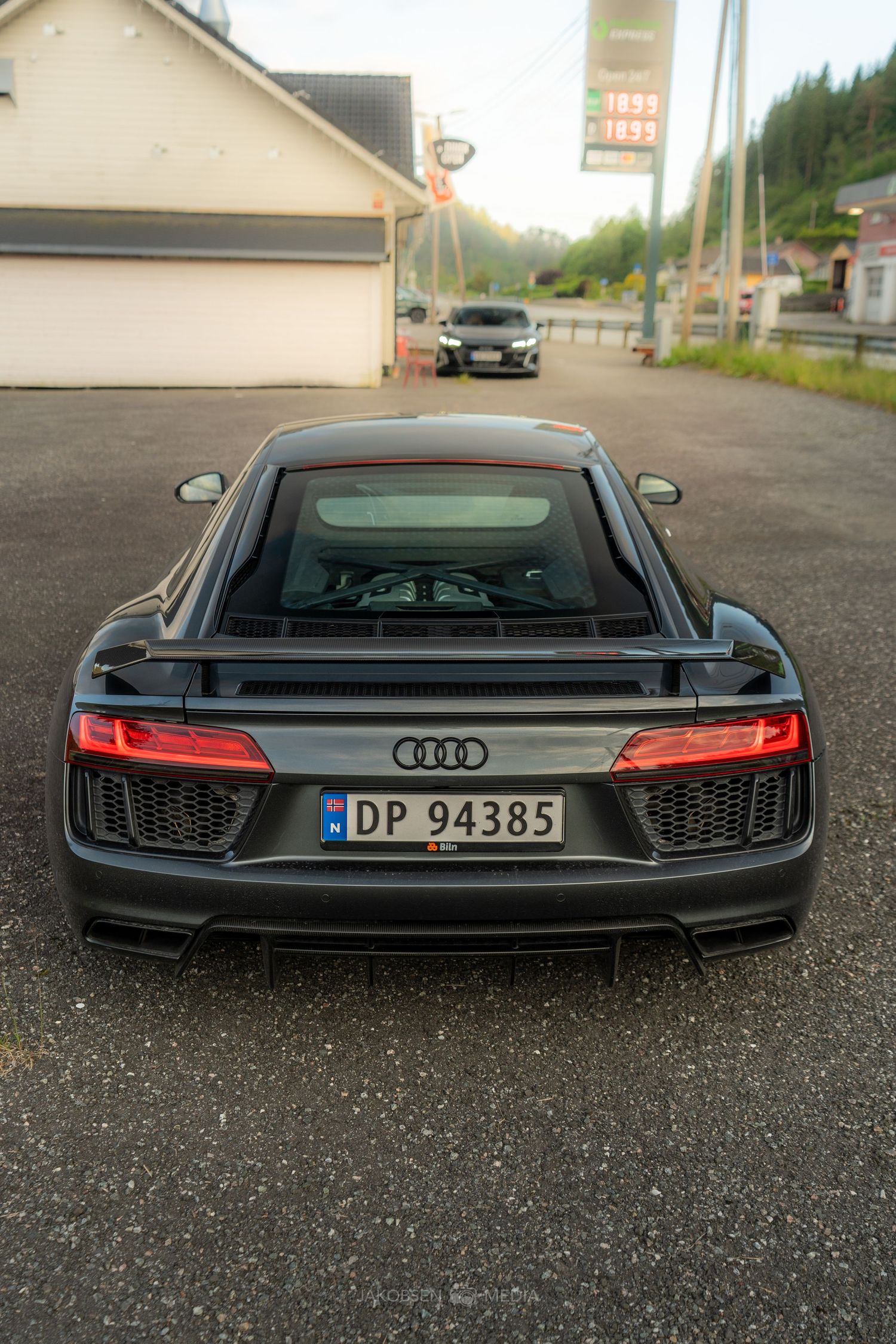 Black Audi sports car shown from three rear angles showcasing sleek taillights and modern design features.