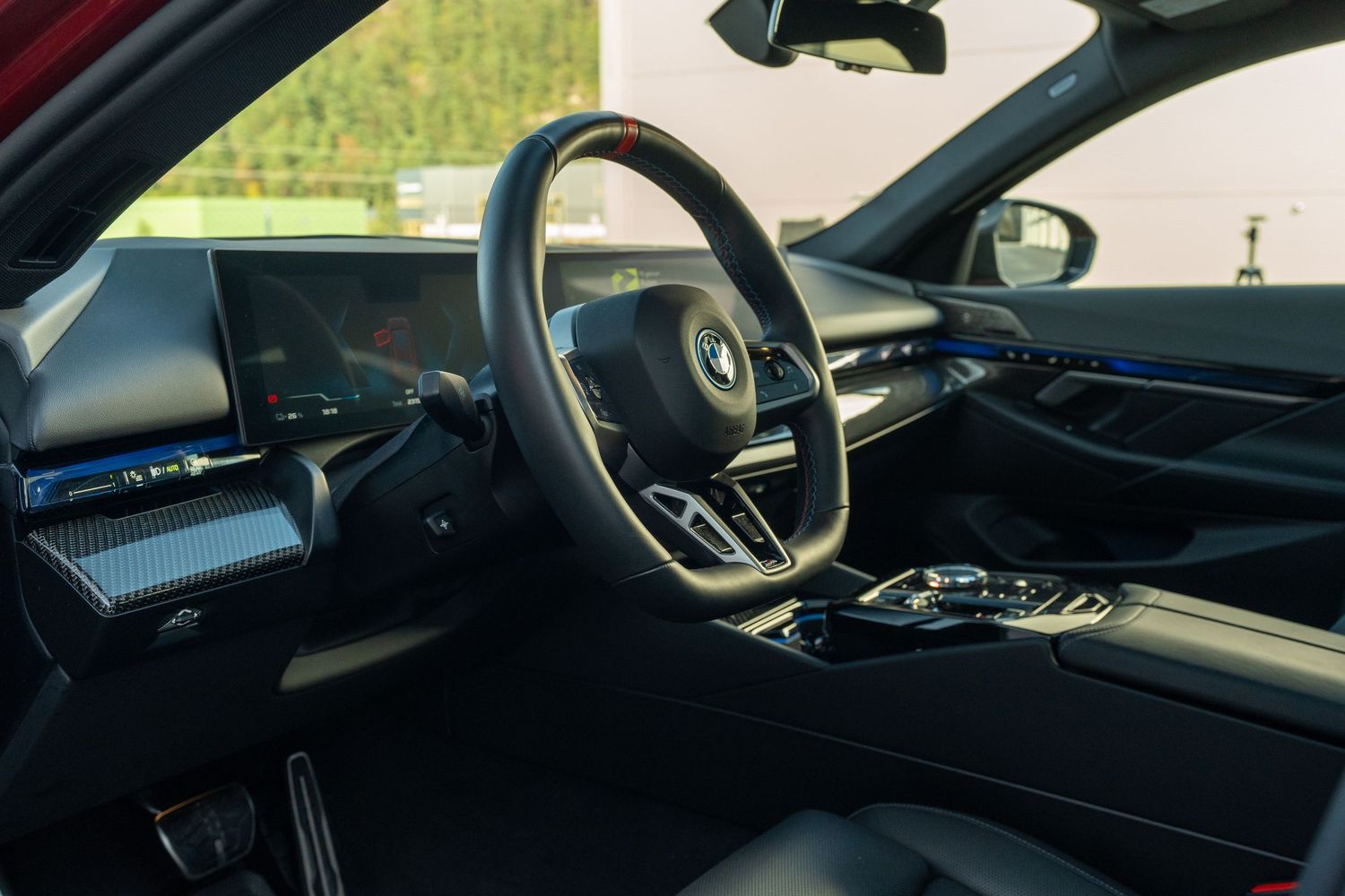 Driver's side interior view of BMW showing dashboard and steering wheel.