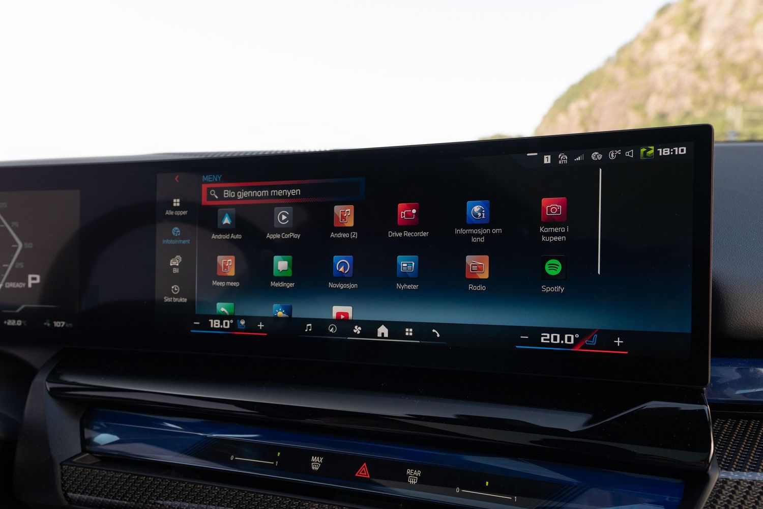 BMW curved display showcasing digital gauges and navigation interface with minimalist design.