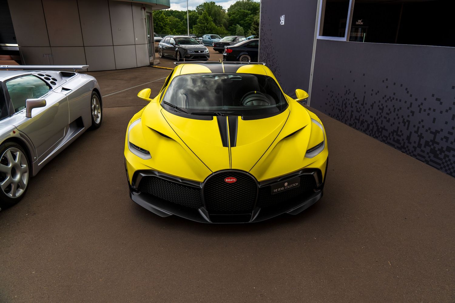 Yellow Bugatti Chiron with black accents and aggressive aerodynamics on display.