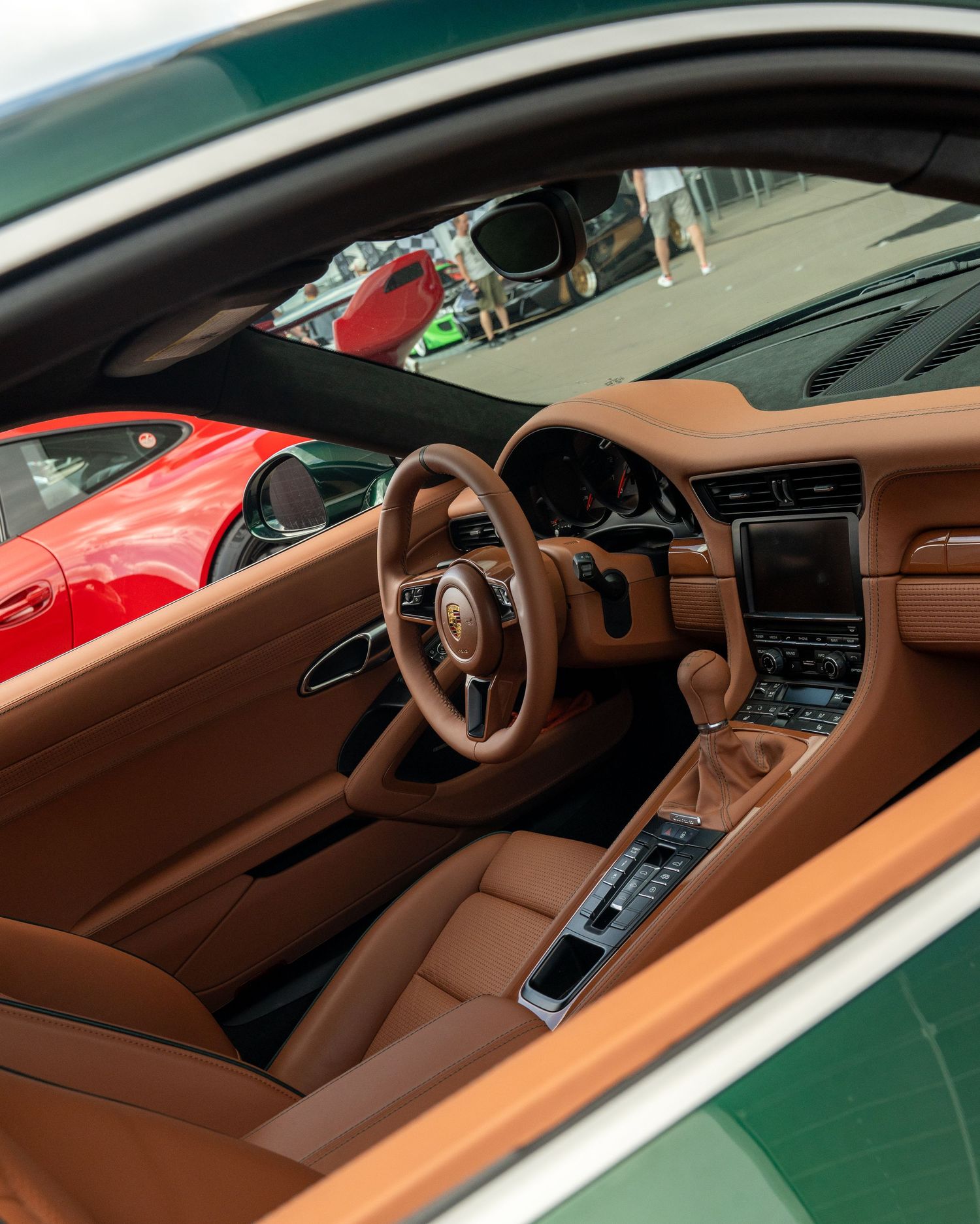 Luxury sports car interior featuring brown leather upholstery and modern dashboard design.