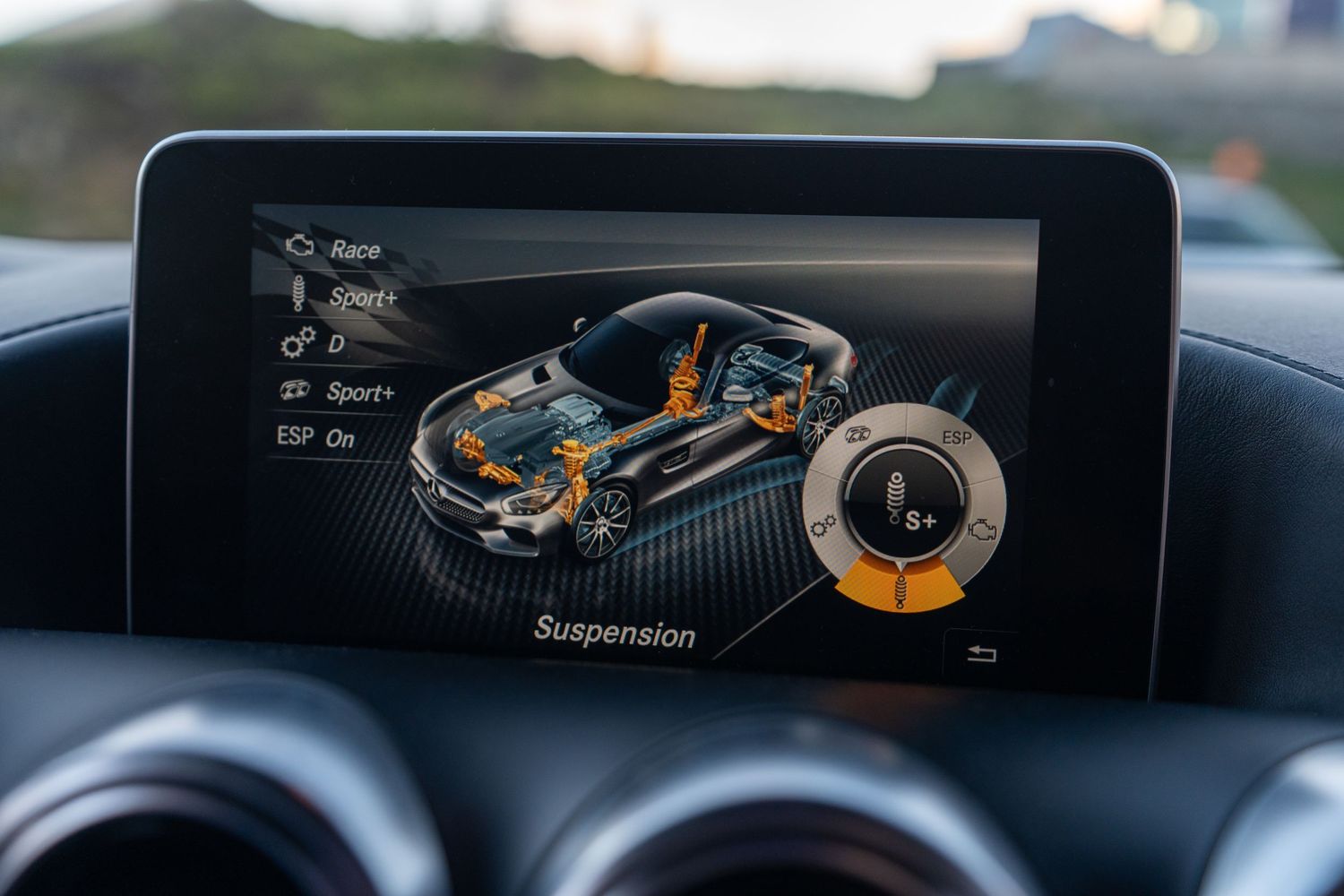 Mercedes digital dashboard display showing vehicle suspension system animation on infotainment screen.