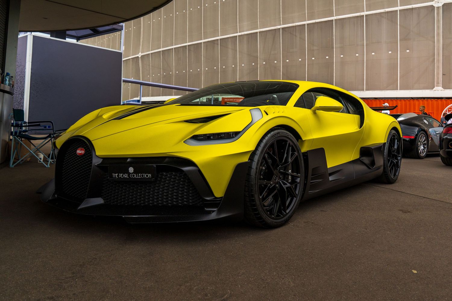 Yellow performance vehicles displayed at automotive showcase event.