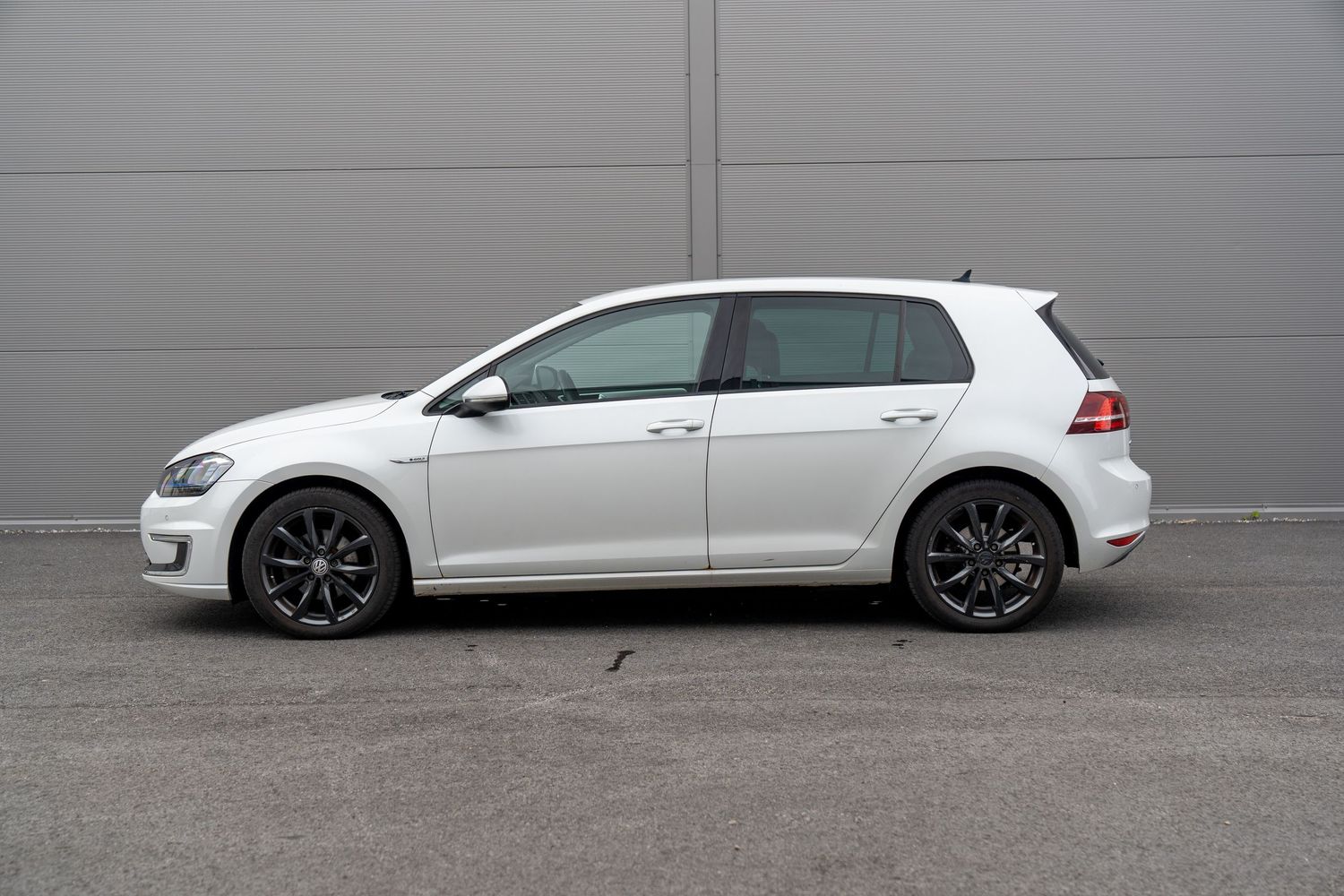 Striking profile views of white Volkswagen GTI car modifications showing staggered ride heights and stances.