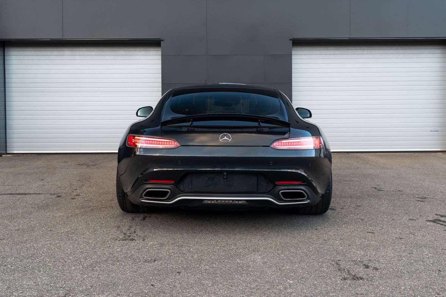 Rear view of Mercedes-AMG GT showing distinctive LED taillights and quad exhaust tips. bergen