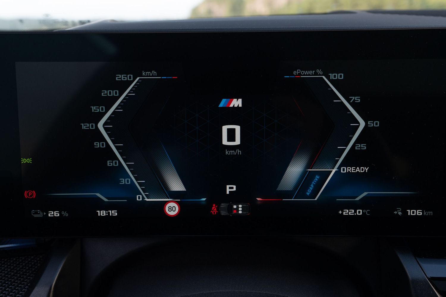 Digital instrument cluster displaying speedometer and navigation in modern BMW vehicle.