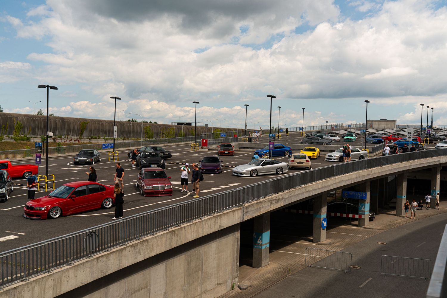 Cars lined up on a multi-level parking structure during an automotive event.