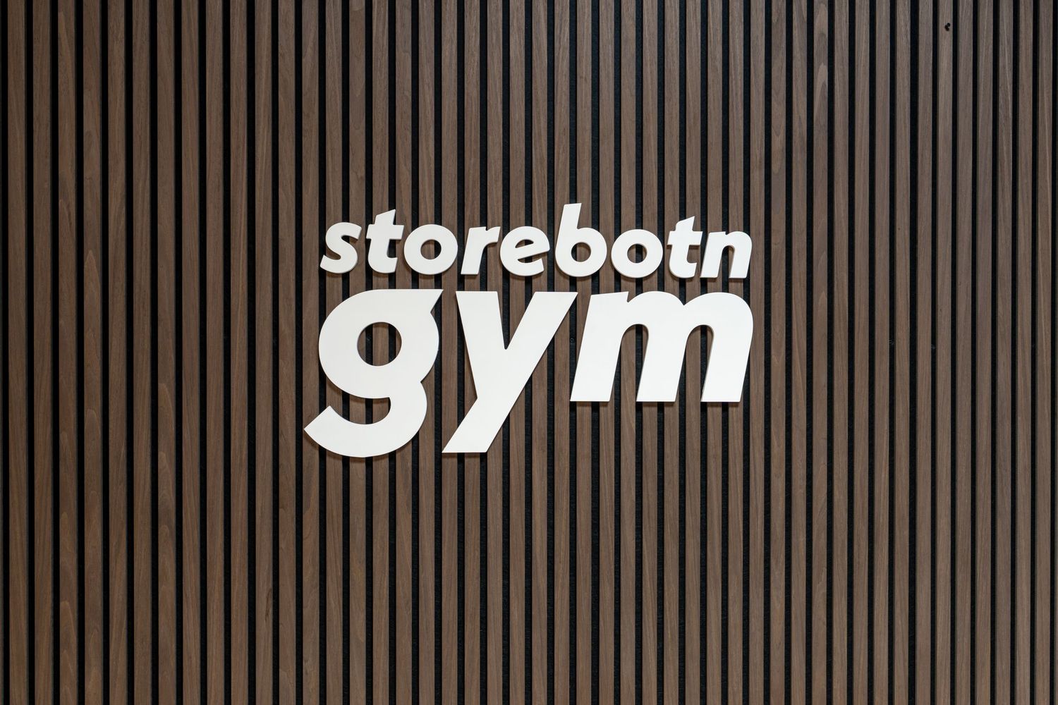 Store logos for 'Storeborn', 'gvm', and 'gym' displayed in white text against a dark striped background.
