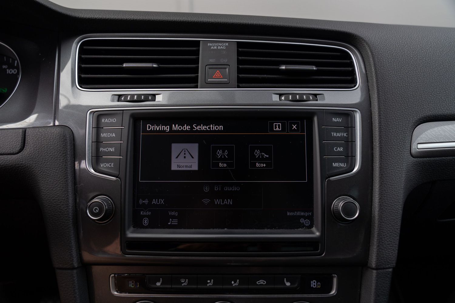 Close-up view of a car dashboard showing a modern infotainment system with multimedia controls.