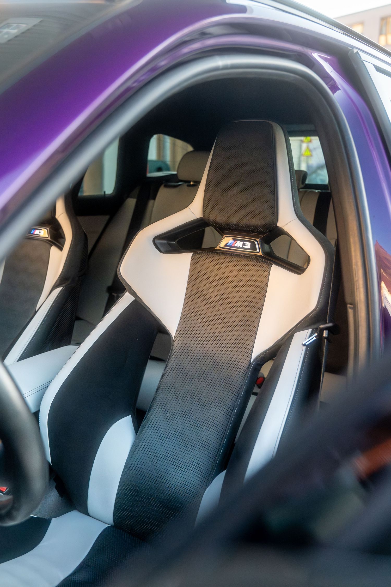 Interior view of high-performance racing seats in black and gray alcantara inside a sporty vehicle.