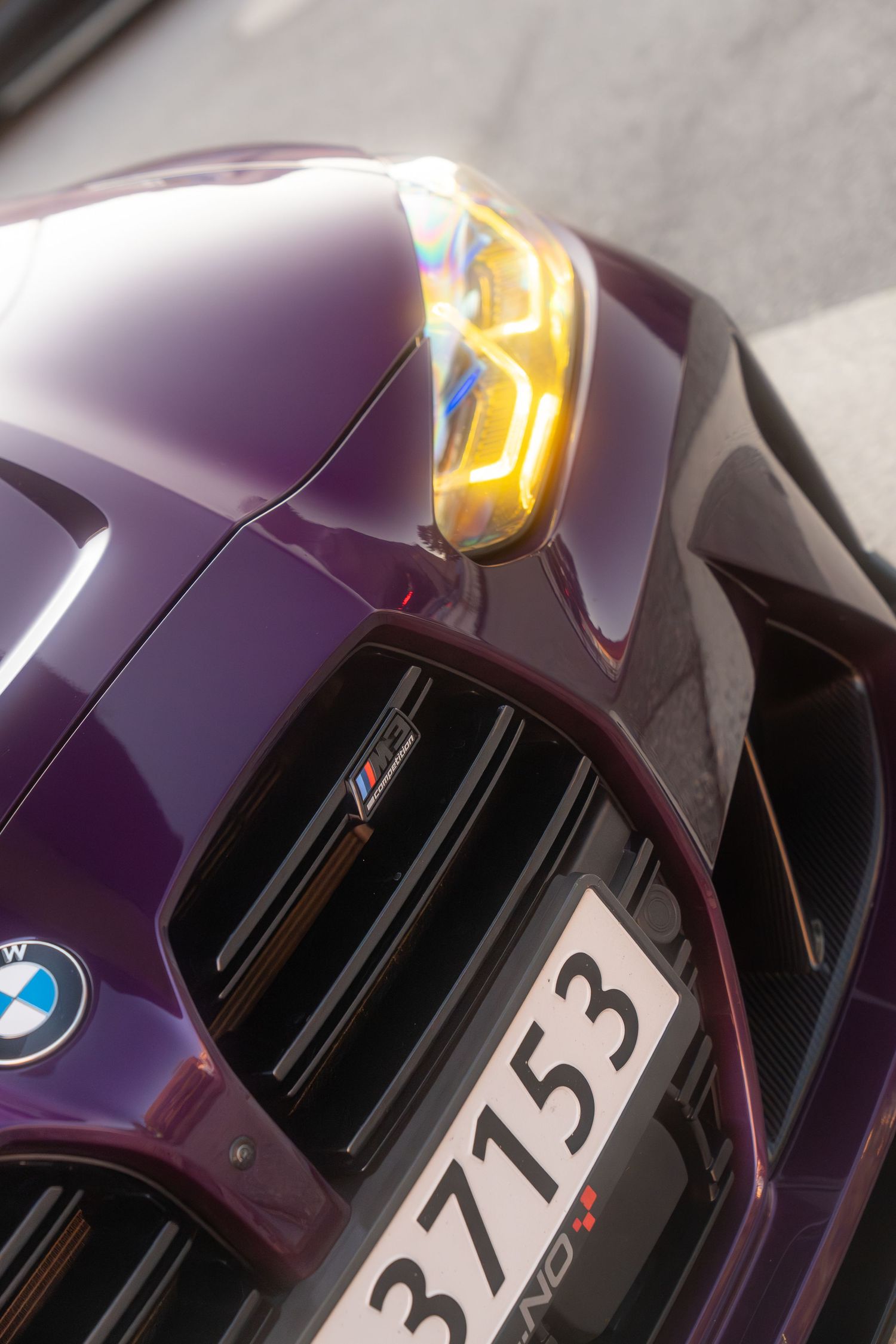 A modern purple BMW M car exterior is shown in a close-up sequence highlighting its sleek design elements.