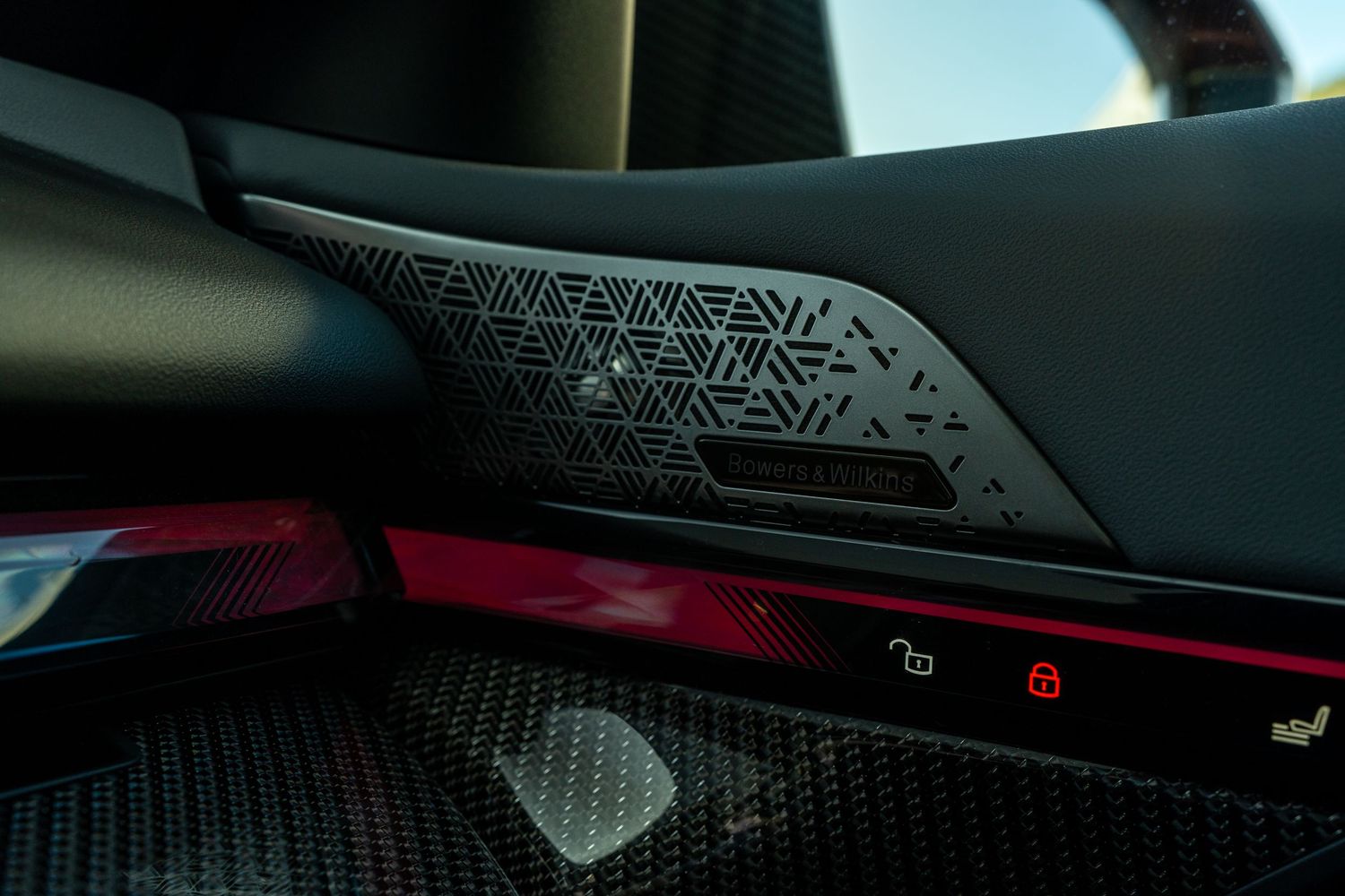 Futuristic BMW digital cockpit interface glowing with blue ambient lighting against dark interior.