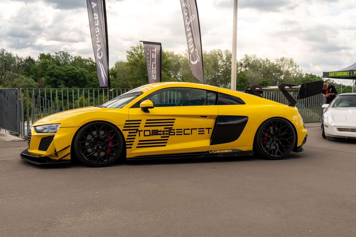 Yellow Audi R8 supercar with racing livery and custom aerodynamic elements on outdoor display.