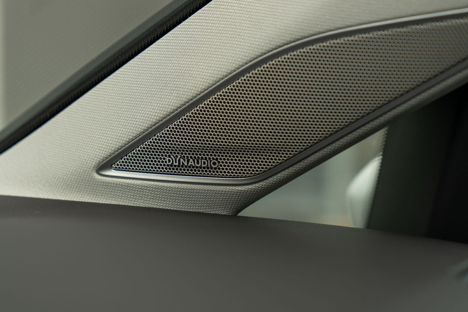 Luxury car interior dashboard showing high-end Bang & Olufsen speaker grille design detail.
