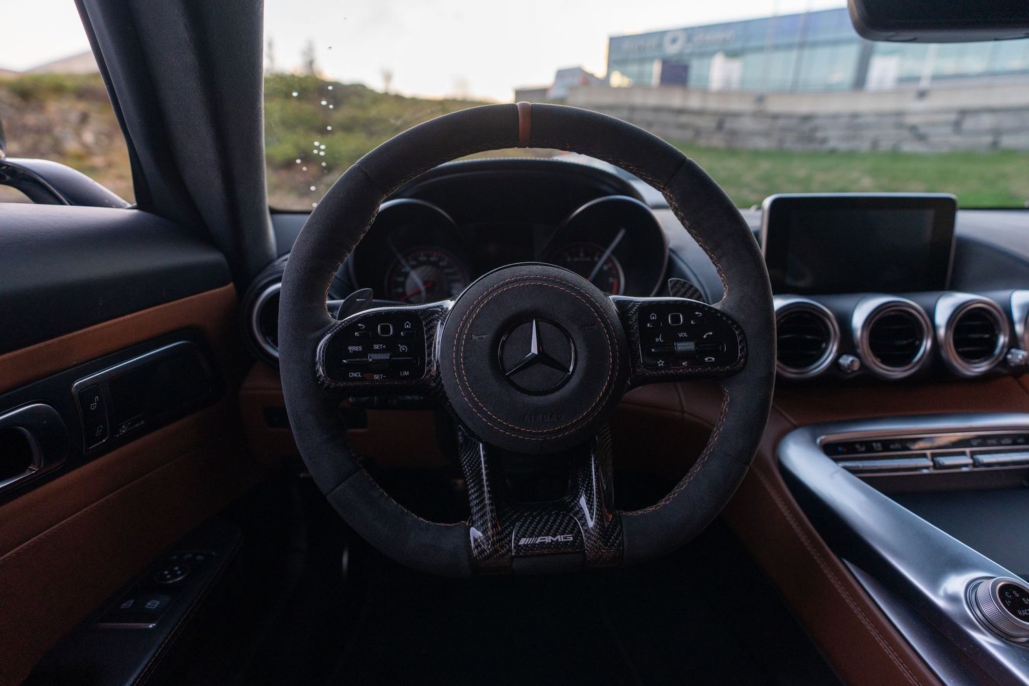 Mercedes-Benz steering wheel and dashboard with digital displays in modern interior. bergen
