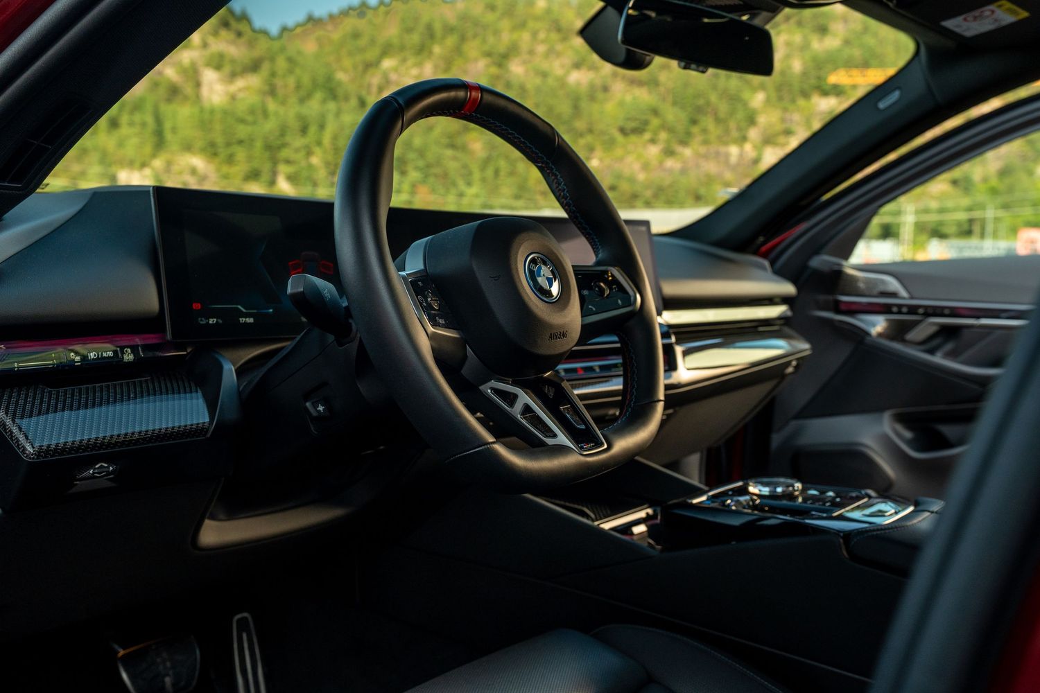 Interior view of a luxury car dashboard showing modern digital displays and ambient lighting.