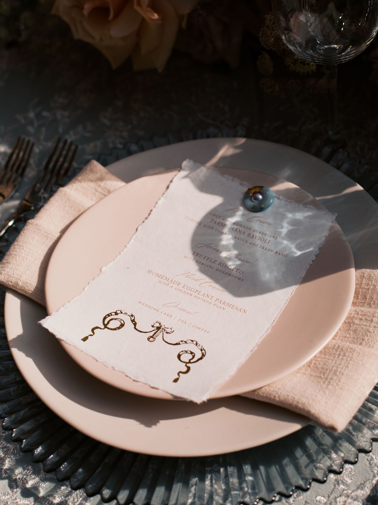 A sequence of plates showing torn paper with decorative gold calligraphy elements creating an elegant table setting.