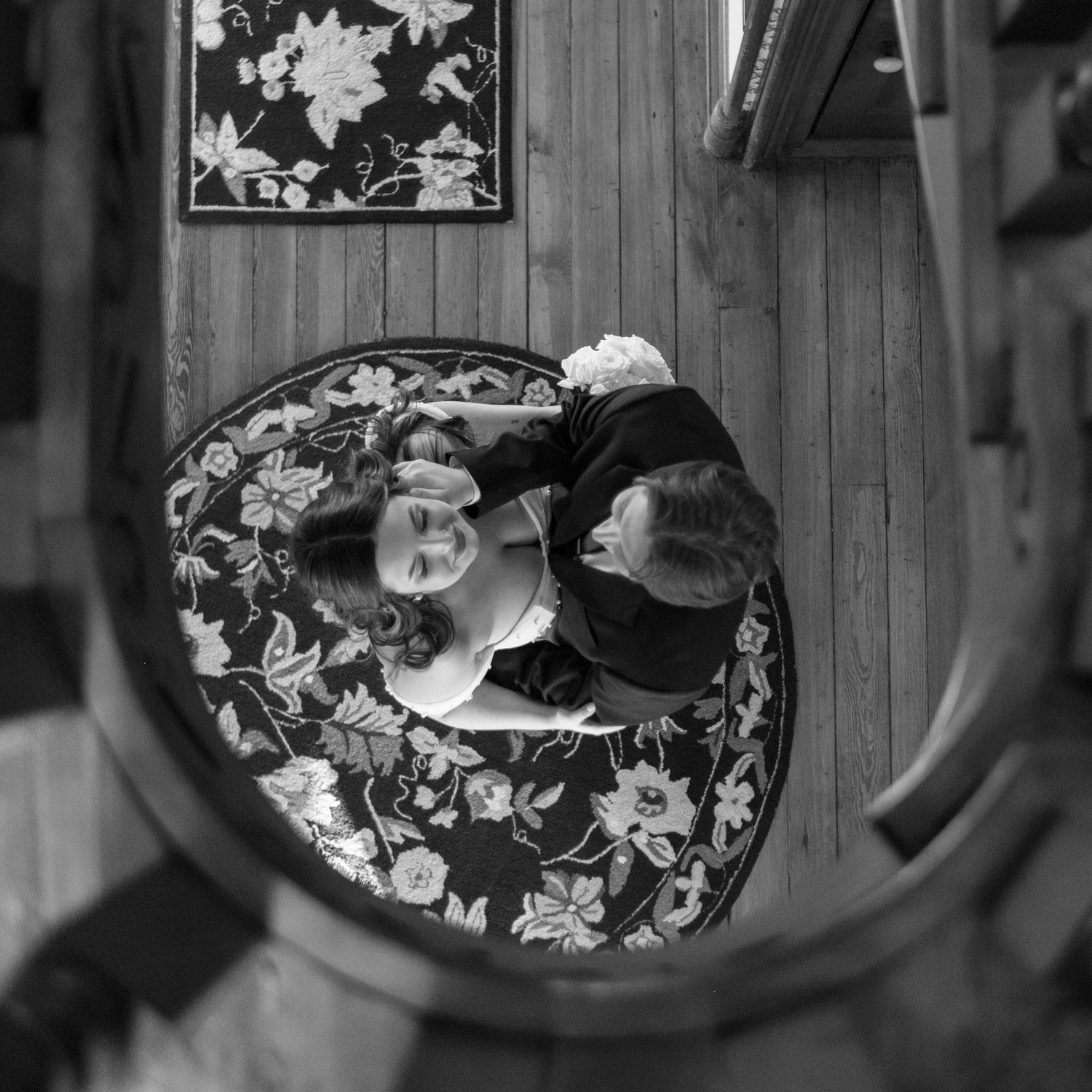 Overhead view of floral arrangement on vintage chair captured in black and white.