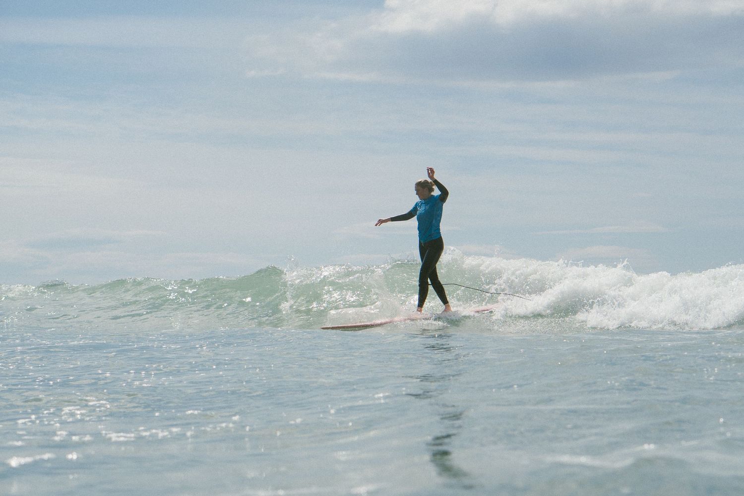 Multiple surfing action shots showing a person riding waves on a bright sunny day.