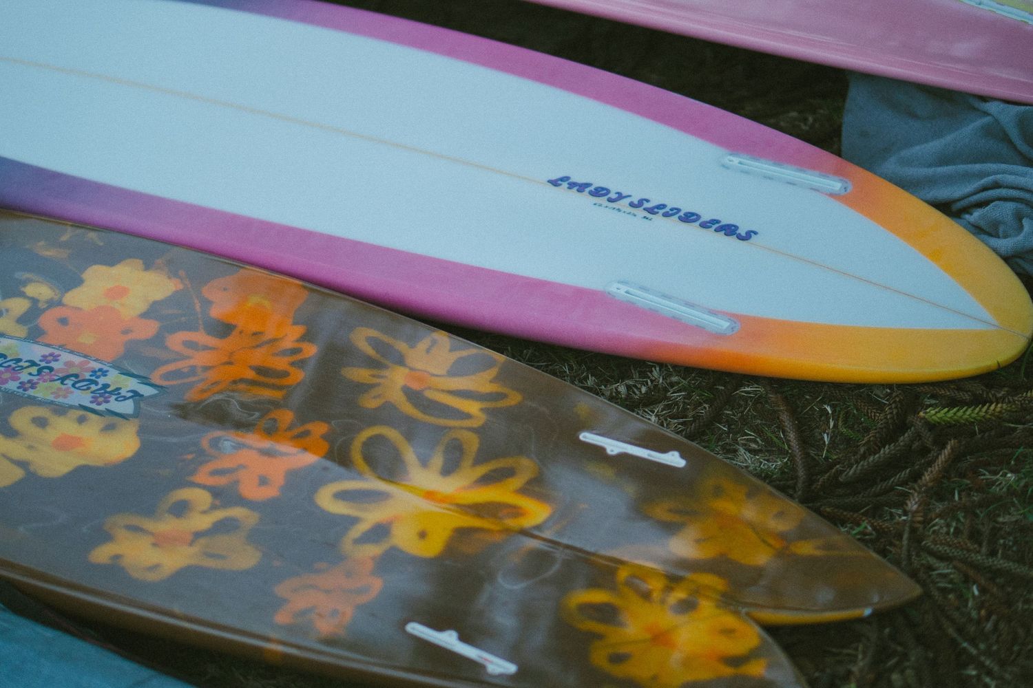 Close-up detail of colorful surfboards with decorative patterns and designs.
