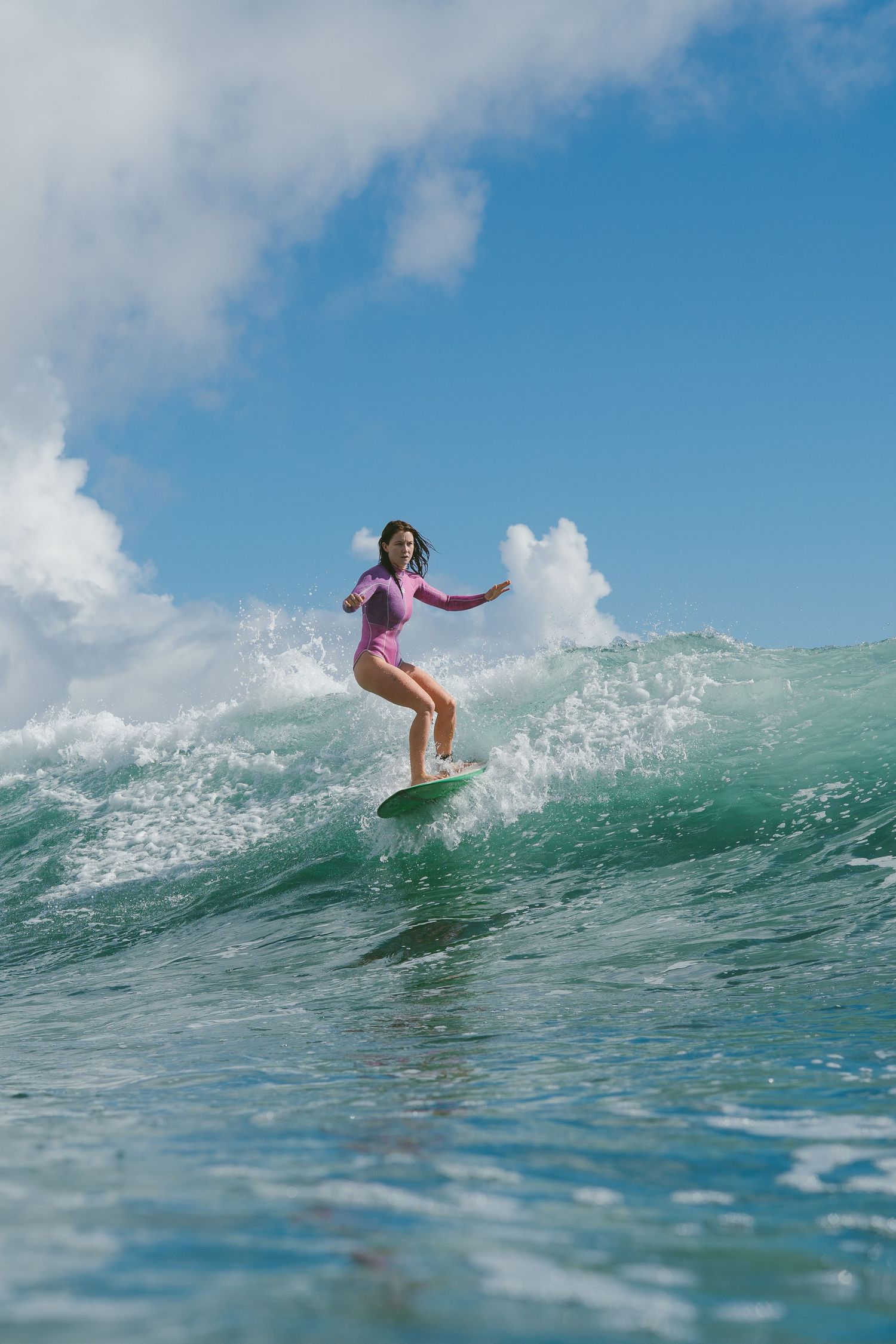 Surfer catching a perfect wave on a bright sunny day.