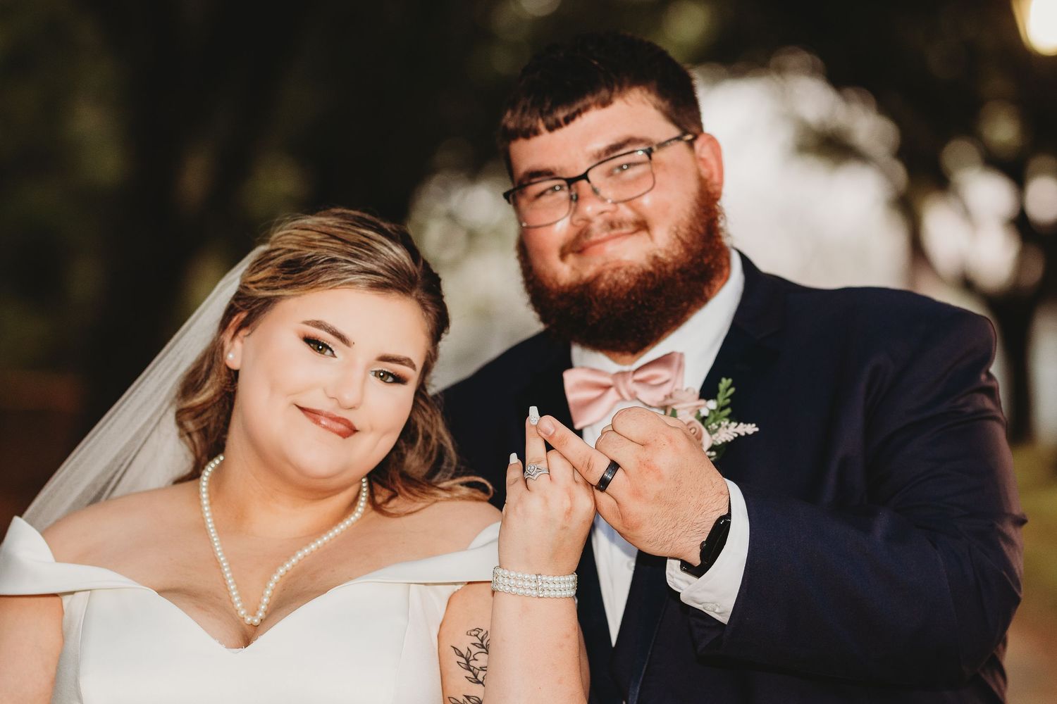 Close-up wedding portraits captured against natural outdoor scenery.