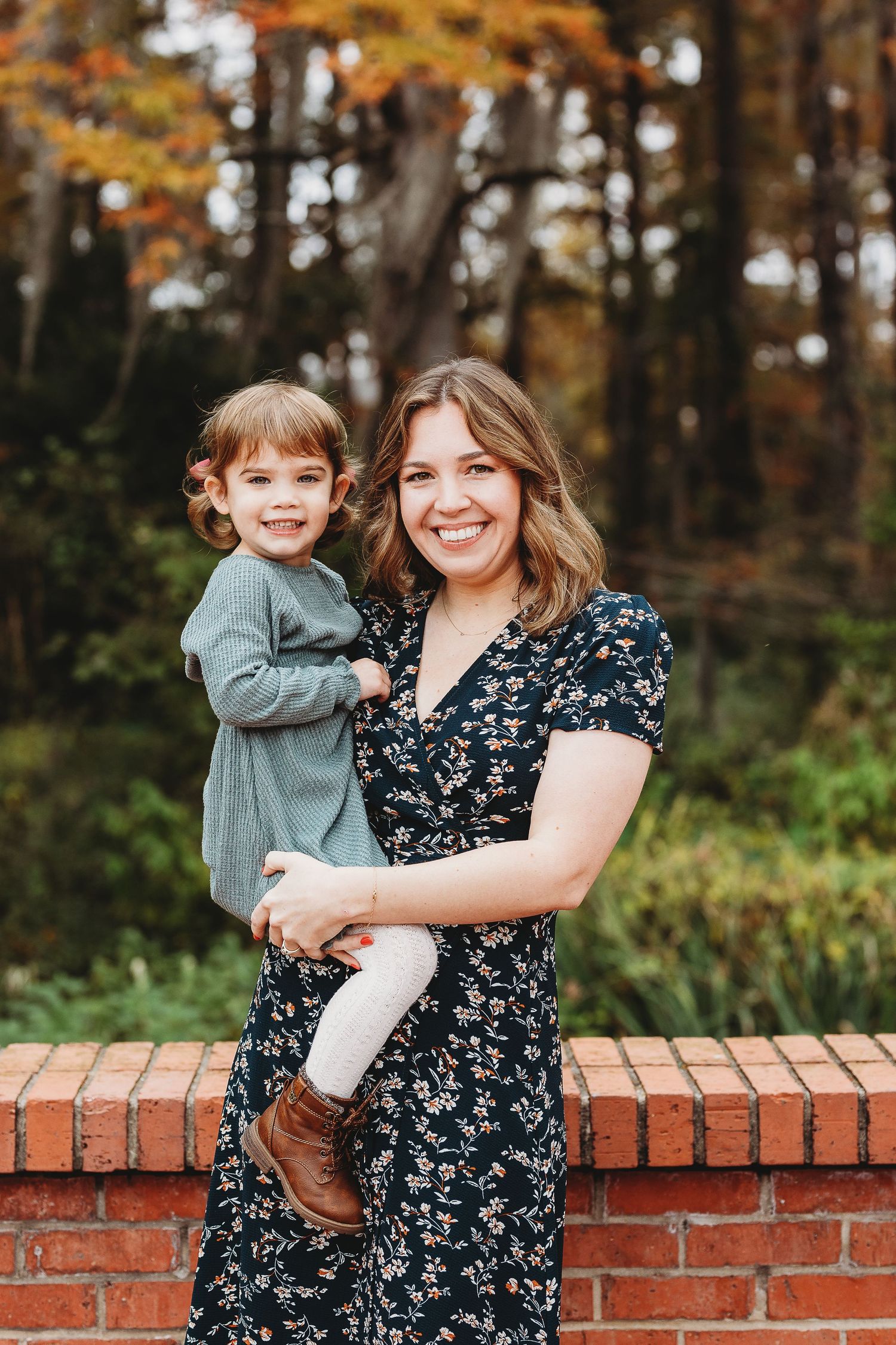 Candid moments captured on a brick wall during an autumn family photoshoot.