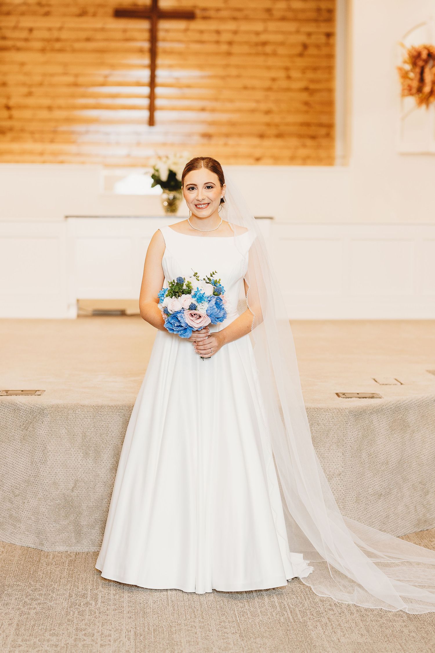 Elegant bridal portraits in a church sanctuary with exposed brick walls and natural lighting.