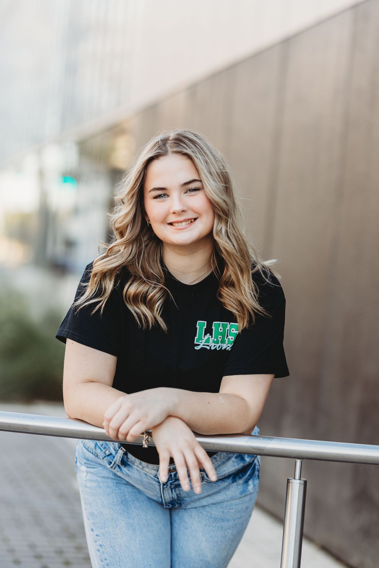 Outdoor fashion portrait featuring casual black shirt and light wash jeans.