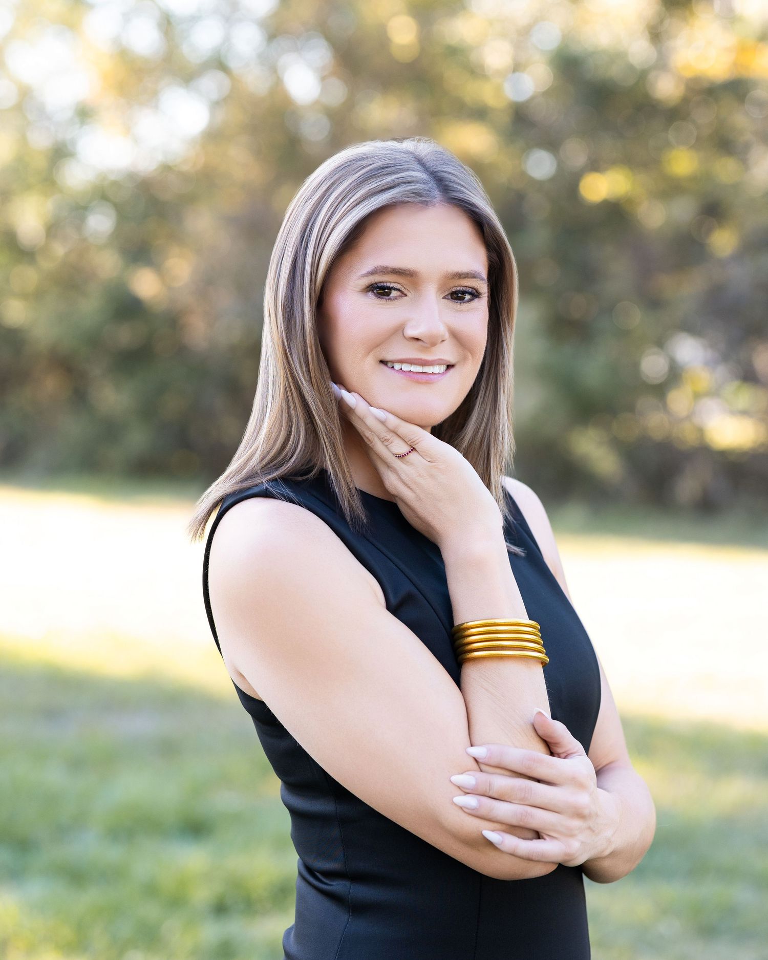 A series of outdoor portrait photos showing someone in a black top posing naturally against a sunlit nature background.
