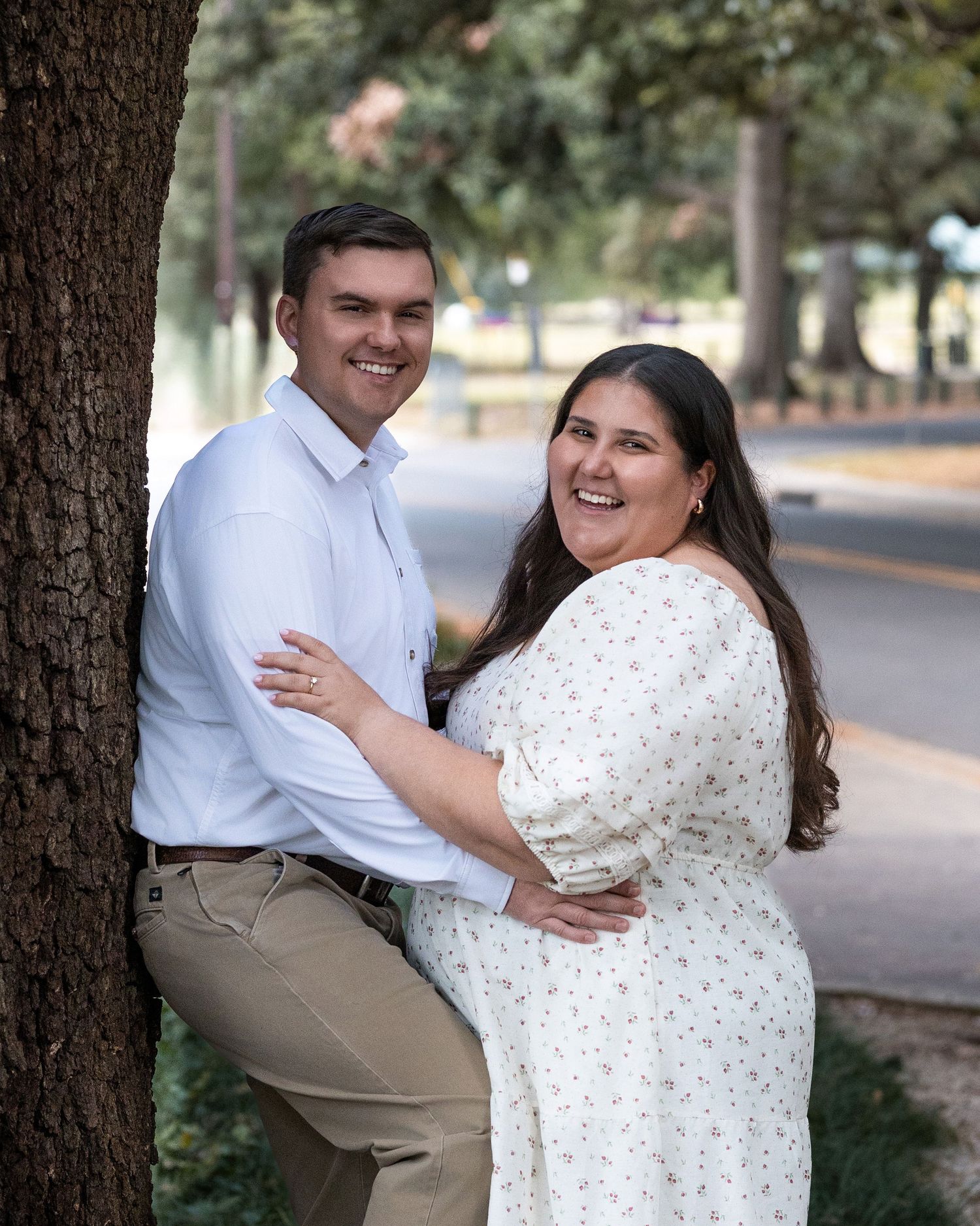 A series of candid moments captured between a couple posing beneath trees during a sunny outdoor photo session.