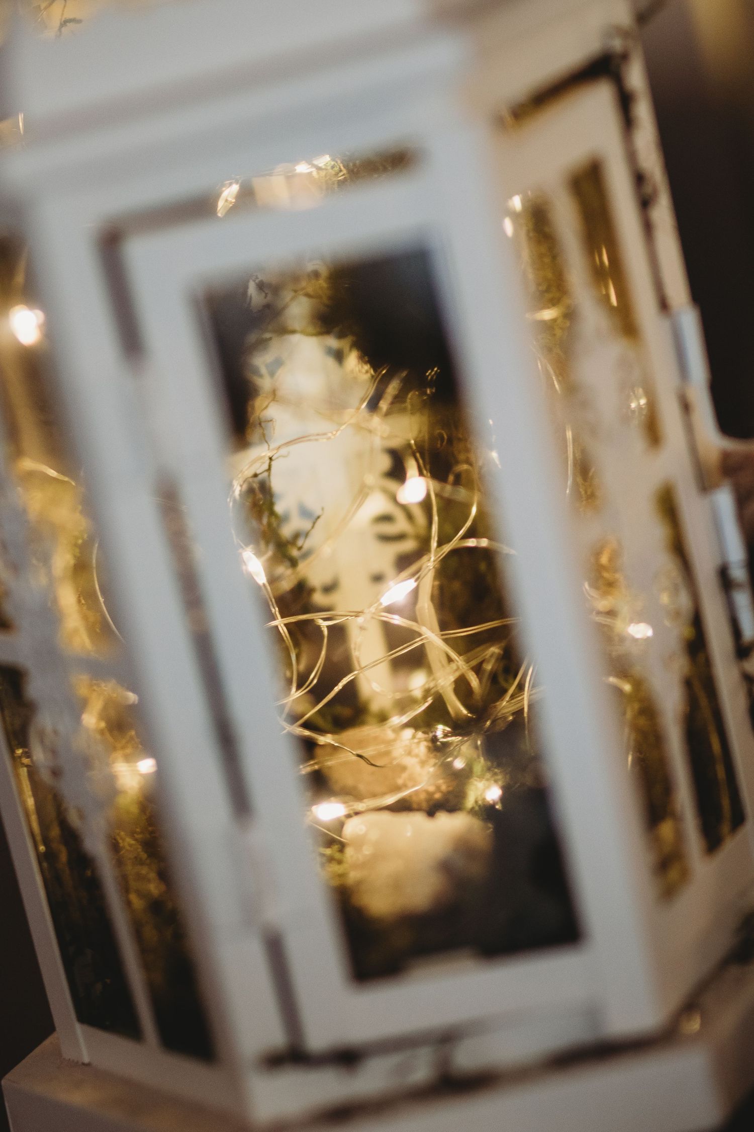 Artistic close-up of a decorative lantern with twinkling lights creating a dreamy bokeh effect.