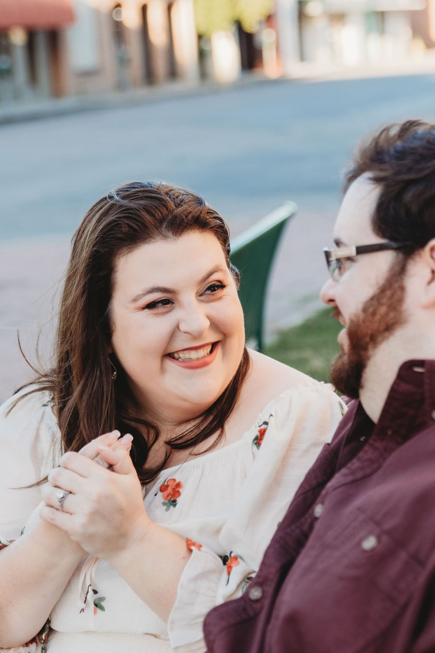 Candid moments of a couple laughing together during an outdoor photo session.