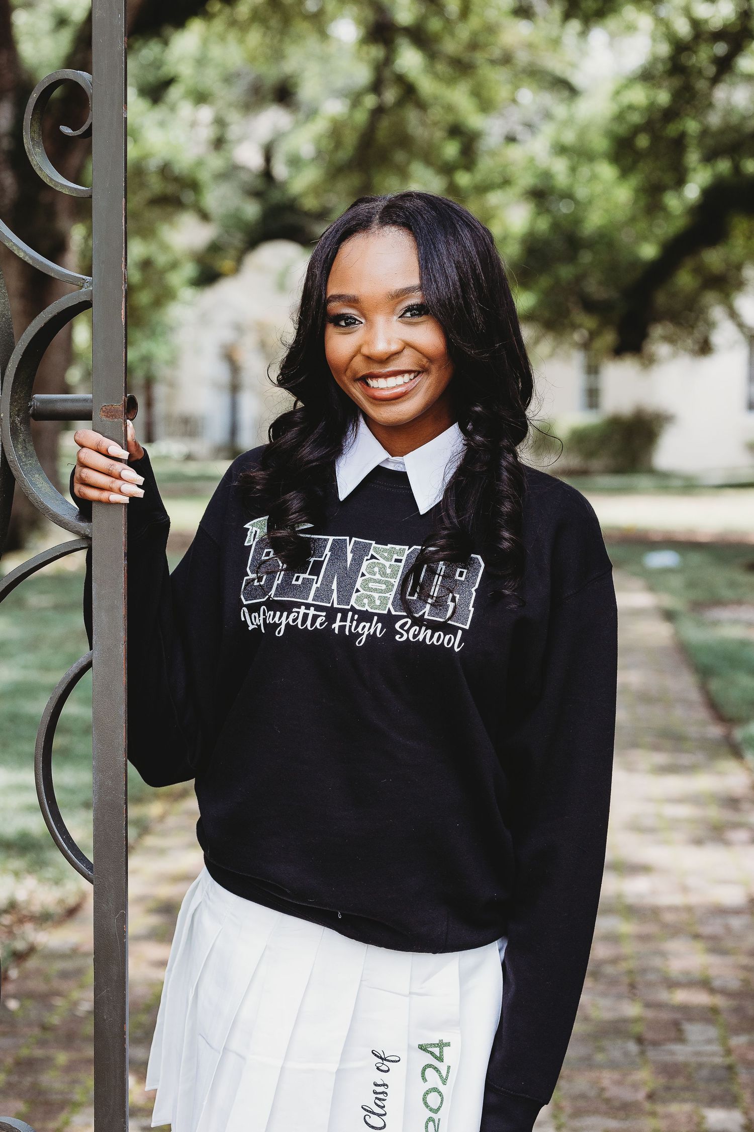 Fashion portraits featuring a black hoodie and white pleated skirt combination.