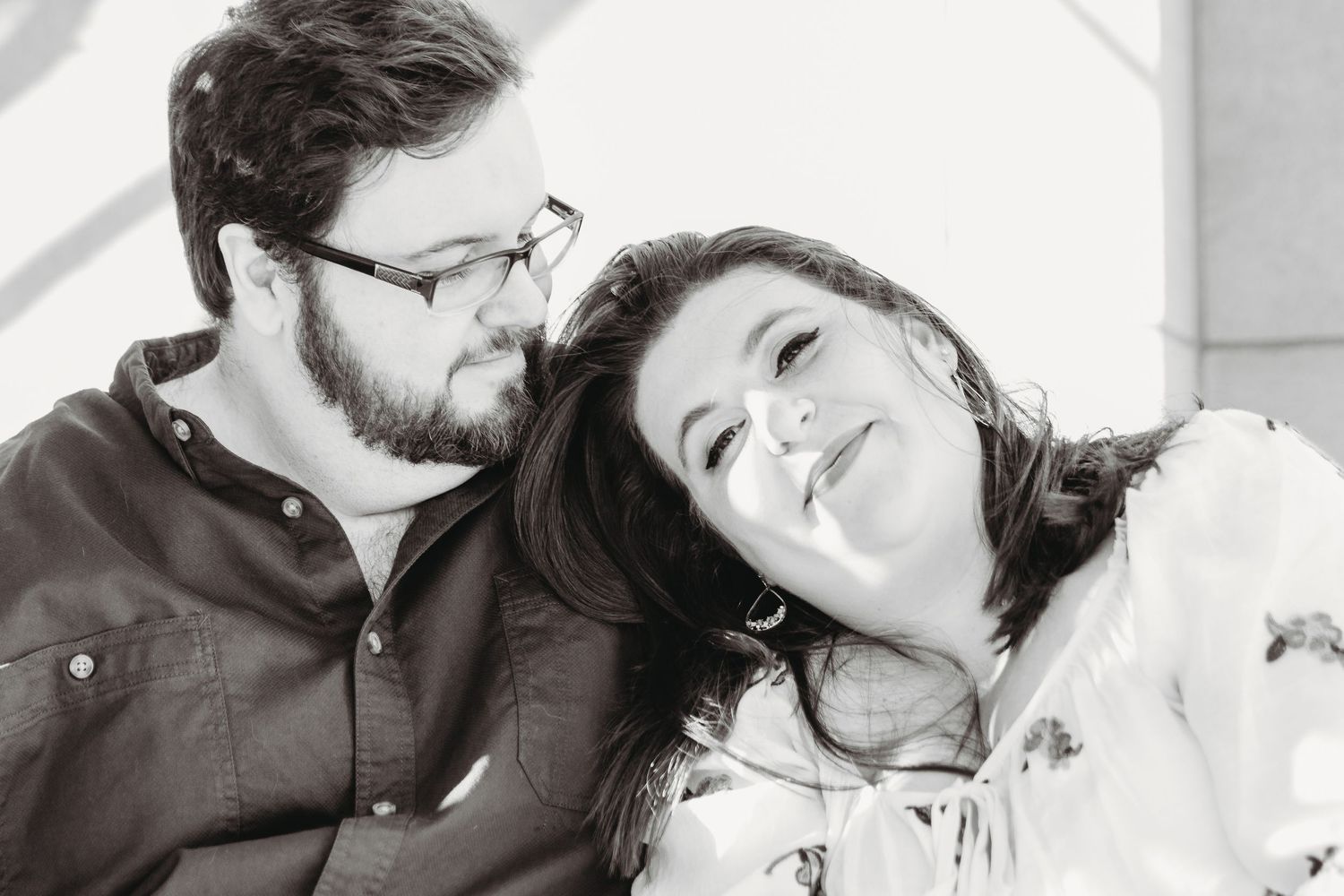 Black and white intimate portraits of a couple sharing tender moments together.