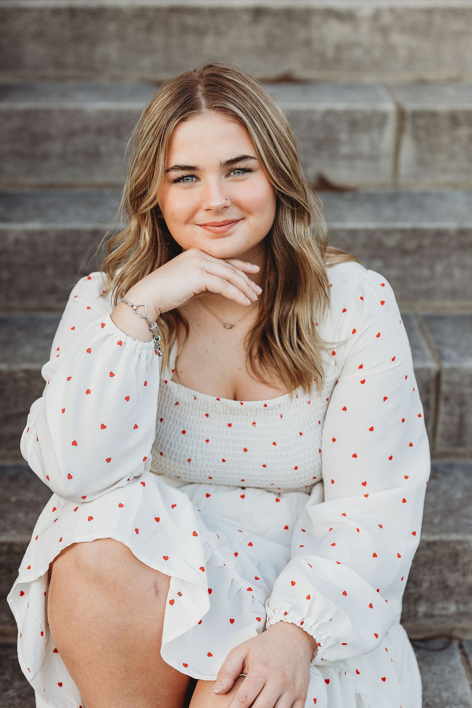 White polka dot dress portrait on concrete steps.