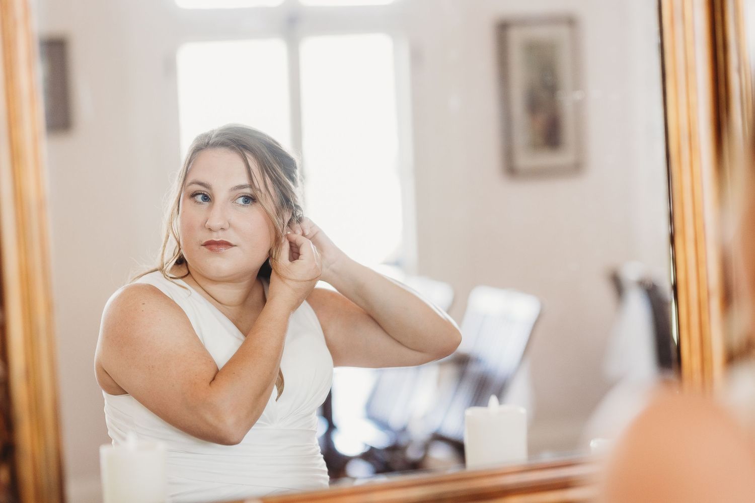 Getting ready scene with bridal preparations in bright sunlit room.