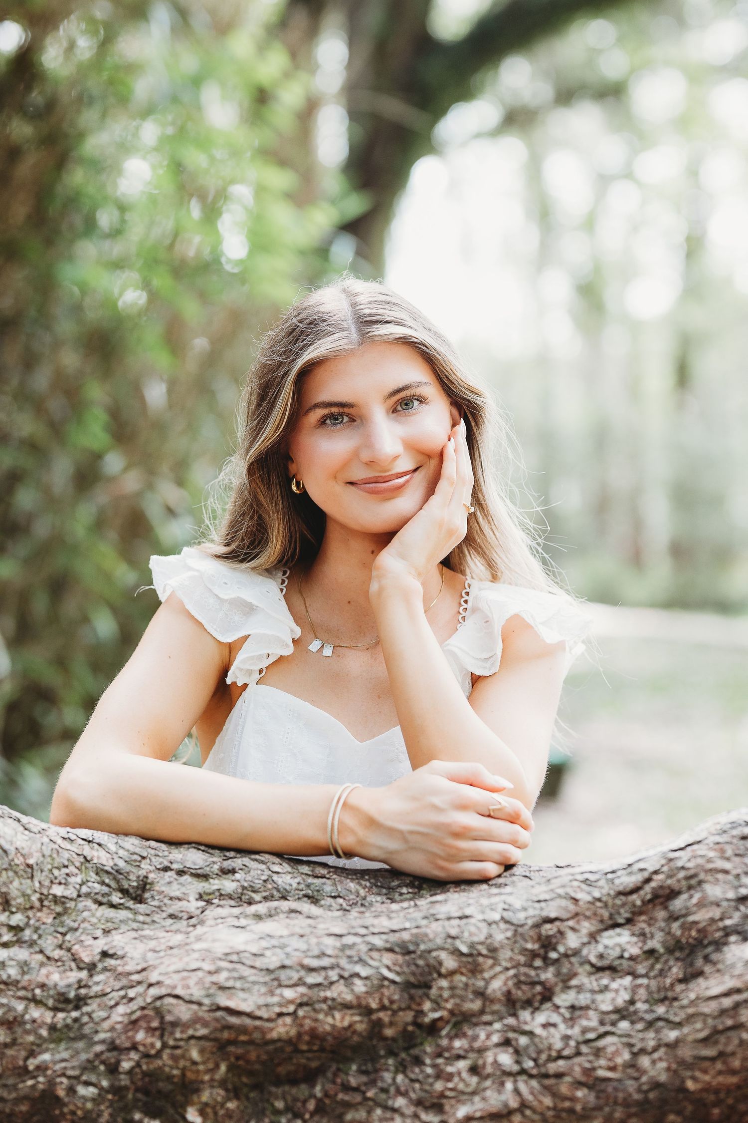A series of outdoor portrait shots showing someone posing playfully against a fallen tree trunk in a natural setting.