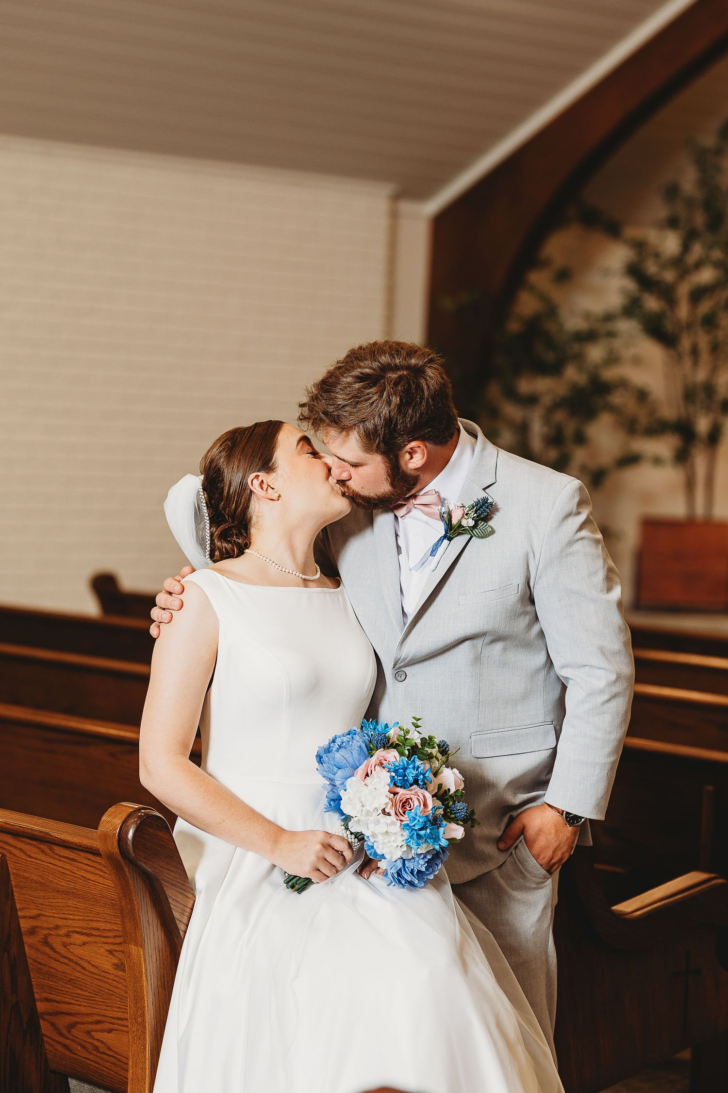 Romantic wedding photos showing tender moments between newlyweds in a church setting.