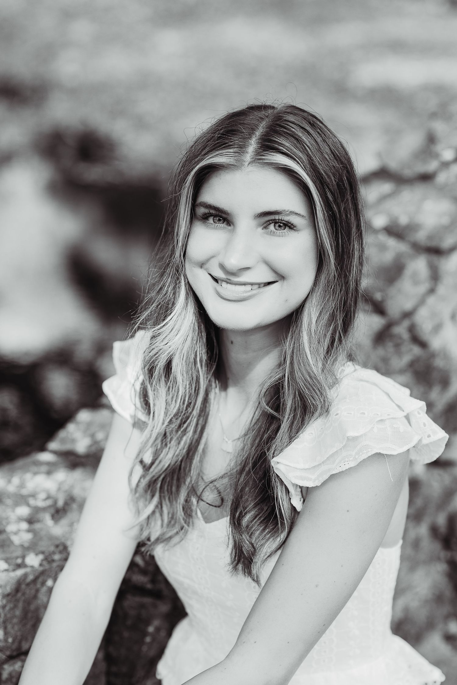 Black and white portrait series showcasing a feminine style with ruffled details and soft lighting.