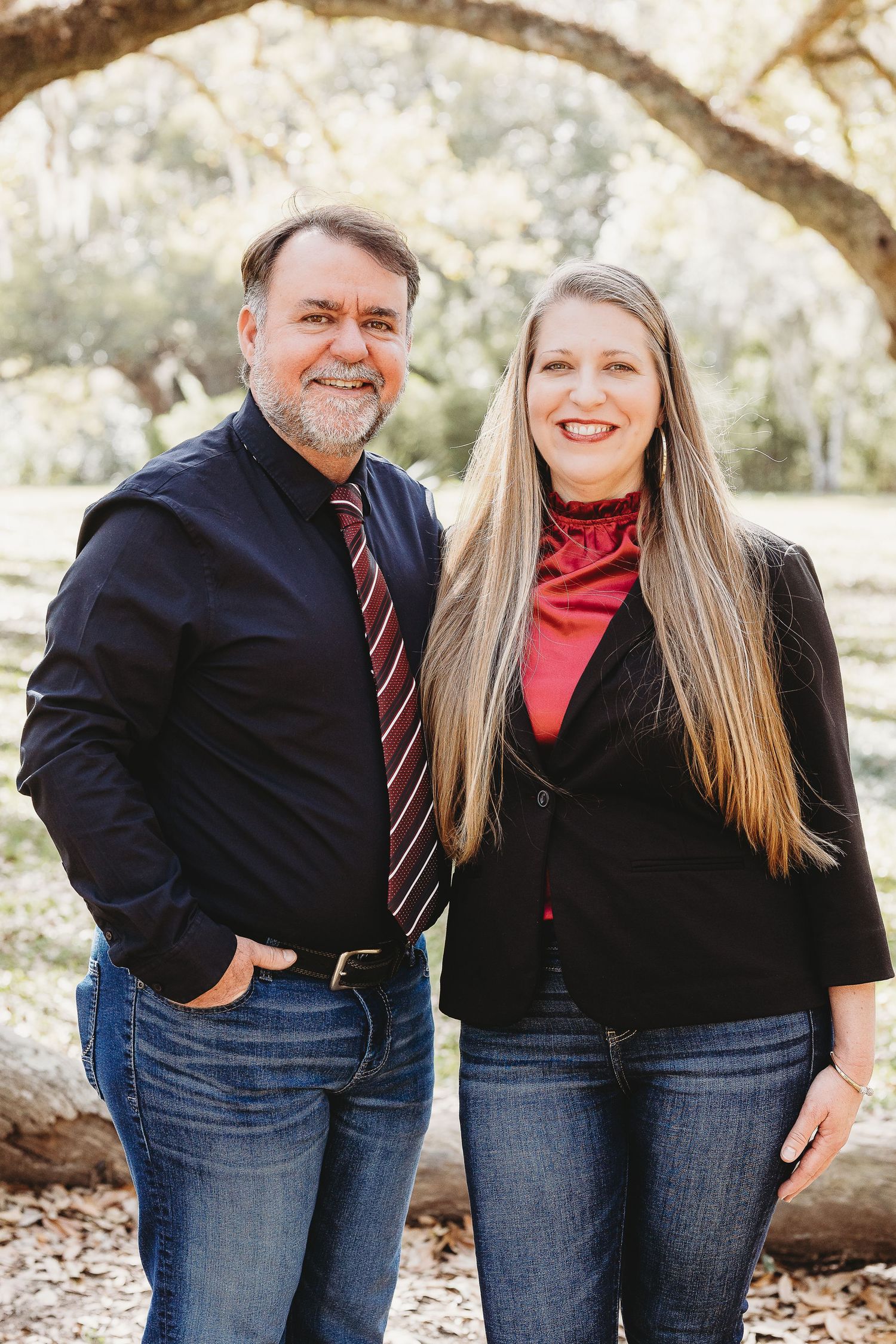 A casual outdoor portrait session with people in coordinating denim and dark tops.